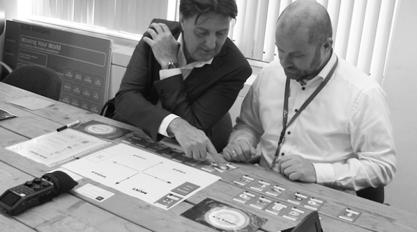 Account managers arranging PaperBird cards during a playtest